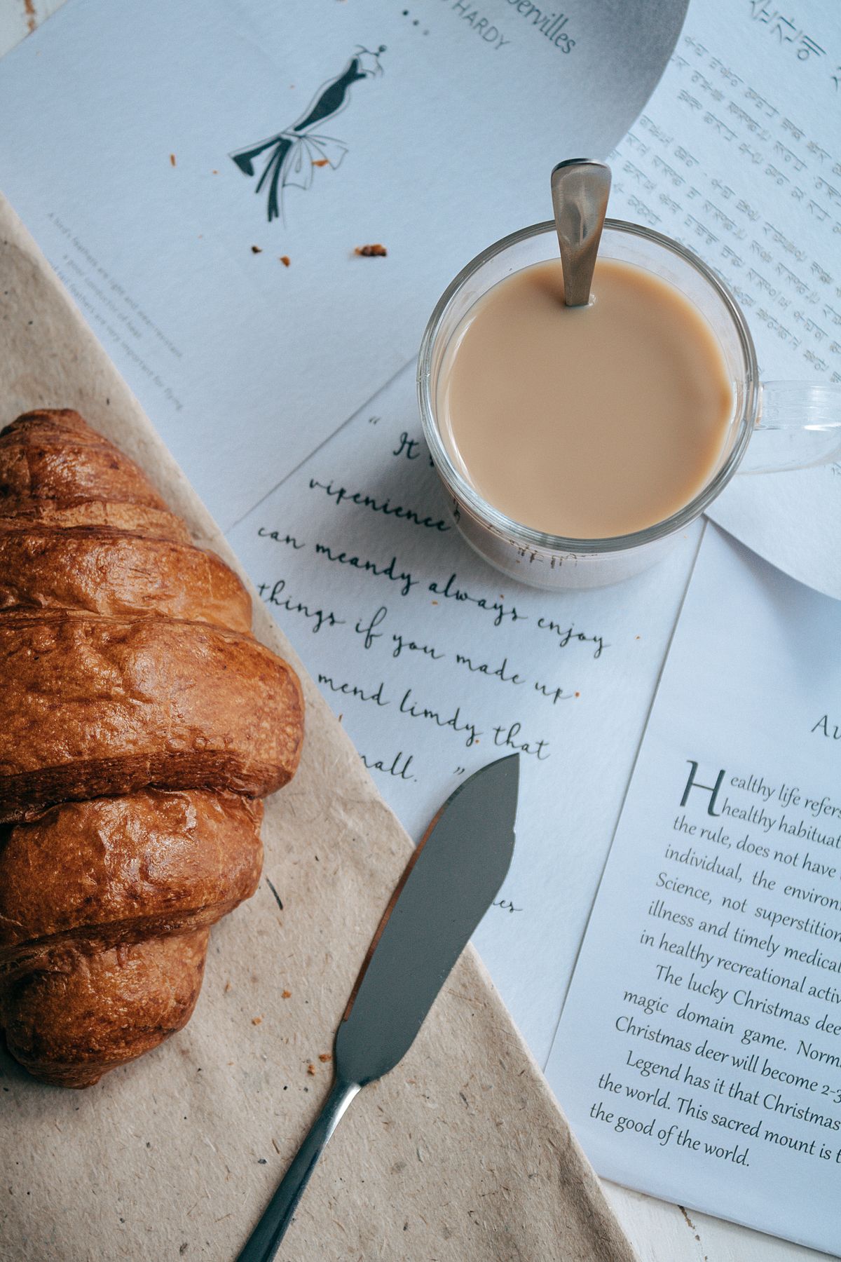 Coffee, croissant and an open journal